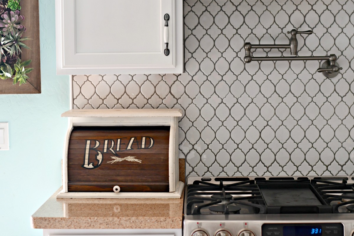 the bread box kitchen counter organizer closed and next to the stove