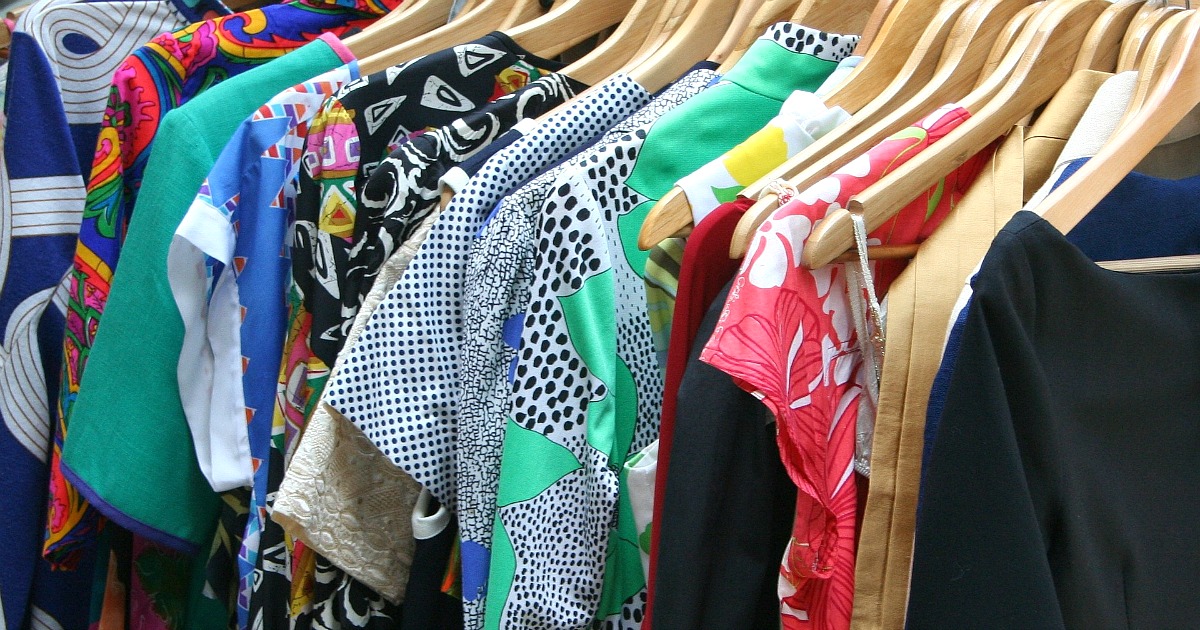 assortment of bright clothes on hangers