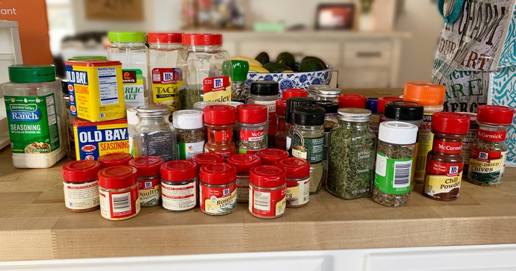 organizing spices - assortment of dried spices on countertop