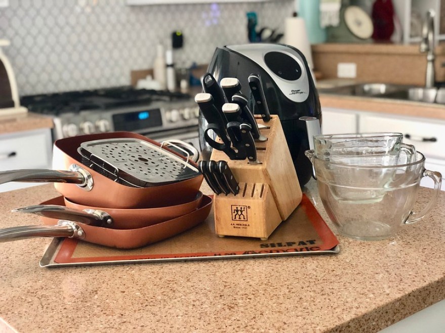 copper cookware, knives, Silpat, and glass measuring cups