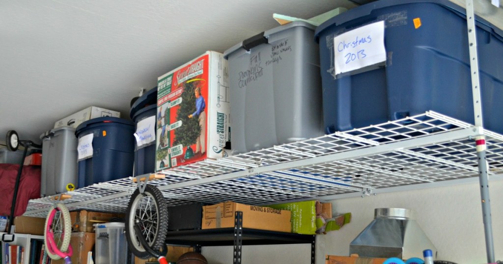 Organized garage with storage on upper shelving 