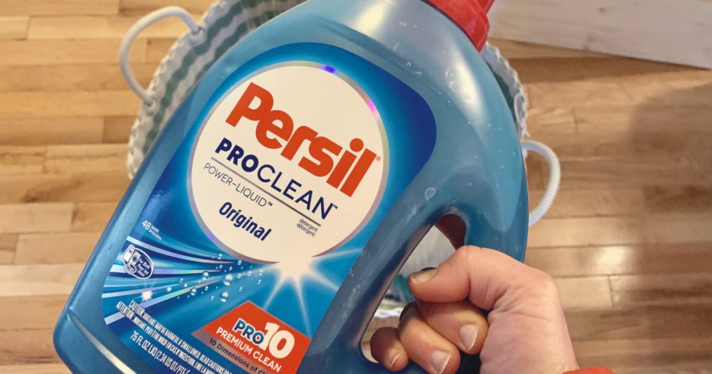 Persil Laundry Detergent - a hand holding a bottle of persil