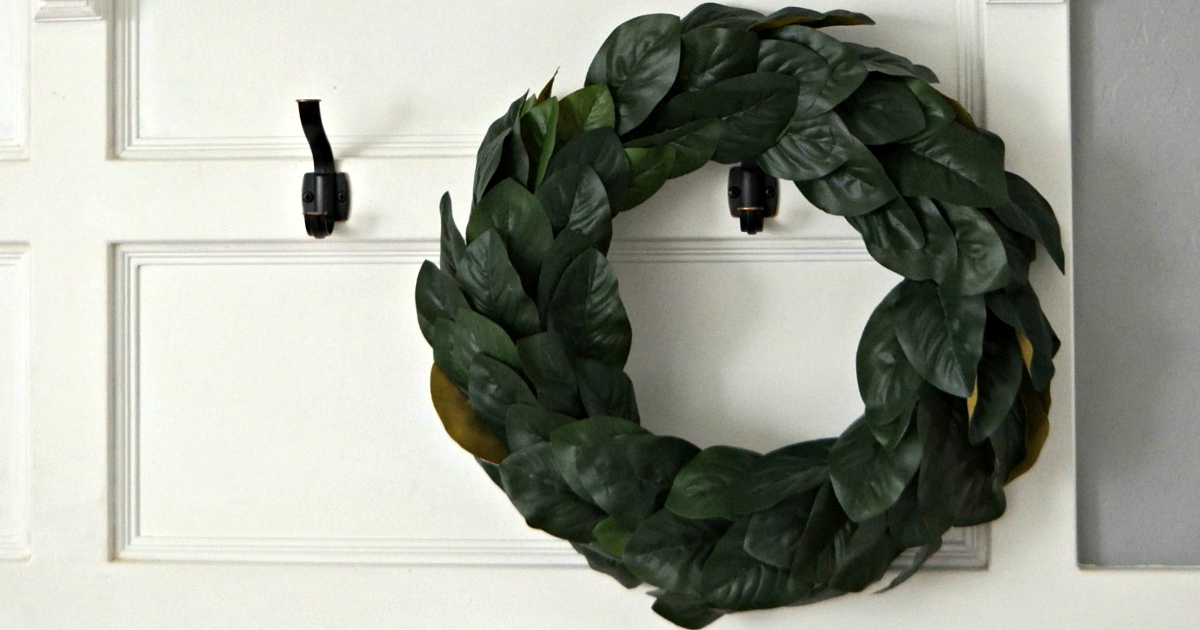 Magnolia lookalike wreath hanging on a wall