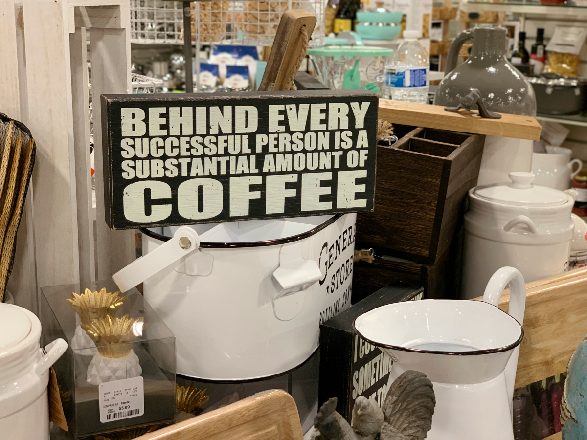 TJ Maxx sign reading "Behind every successful person is a substantial amount of coffee"