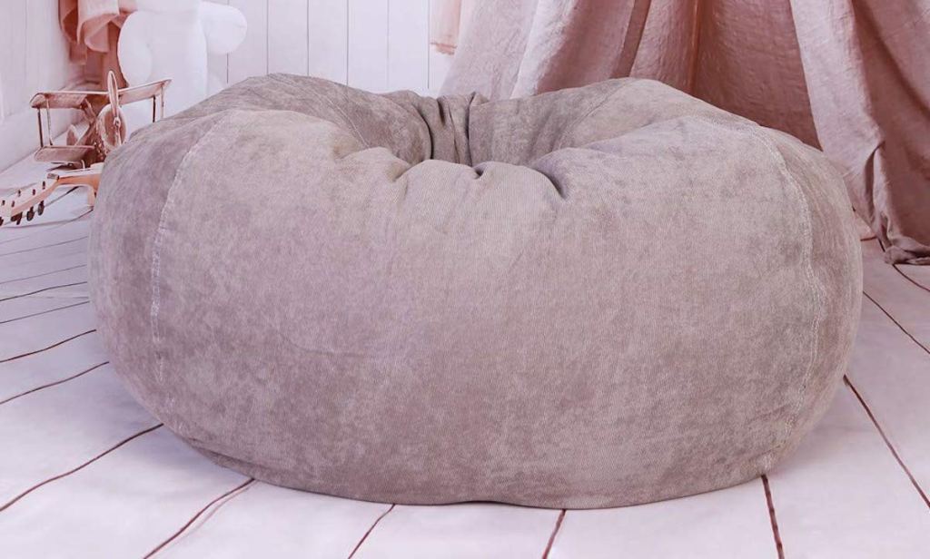 brown tan beige bean bag chair sitting in a pink studio