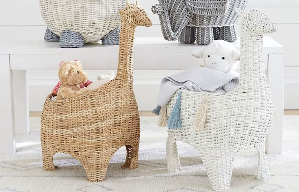 brown tan and white giraffe shaped wicker baskets on floor with stuffed animals inside 