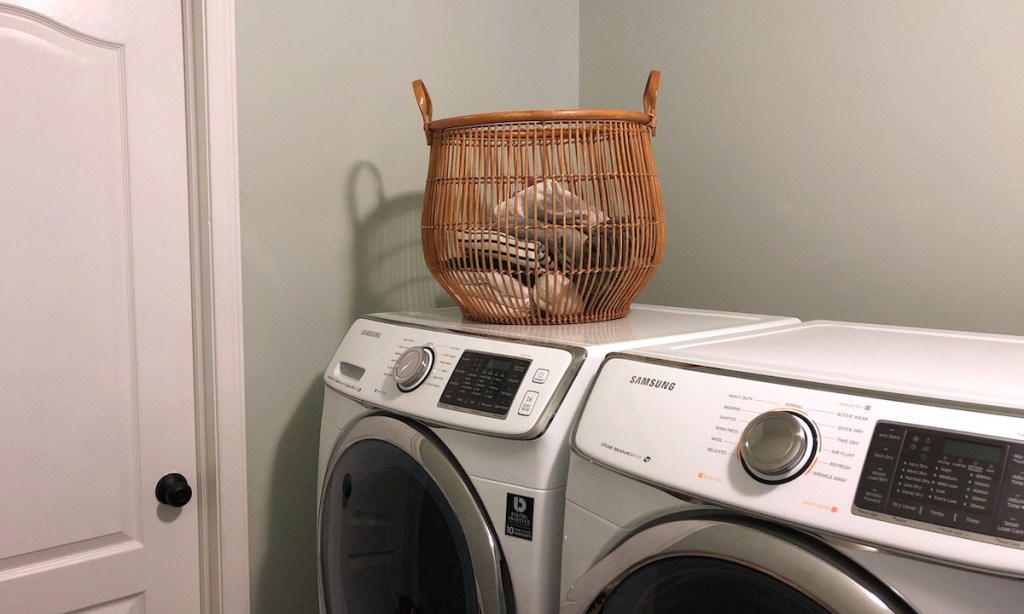 wicker laundry basket on top of washer and dryer 