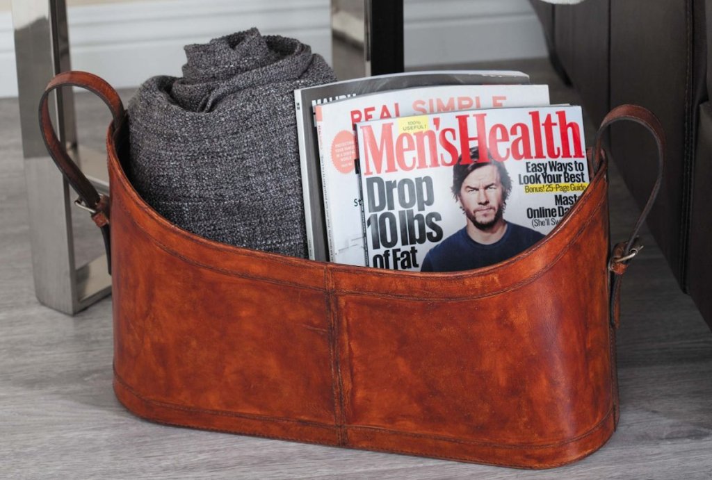 leather basket with blanket and mens health magazines inside
