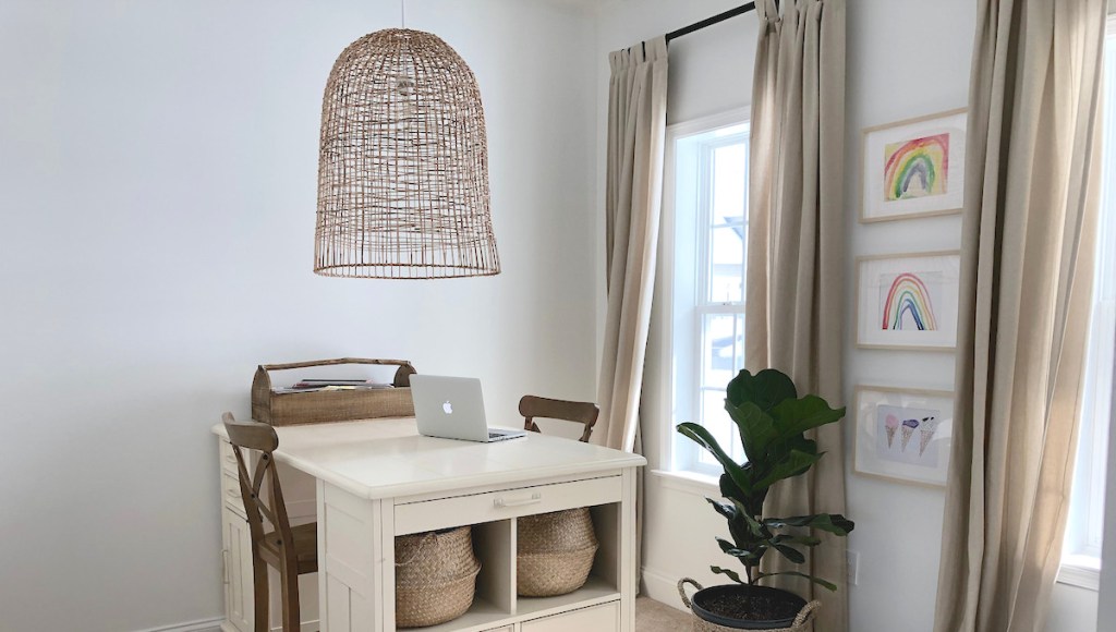 large basket light in office with desk plant artwork on walls and computer