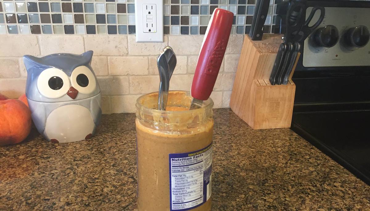 comparison of regular knife with large red peanut butter knife in a jar