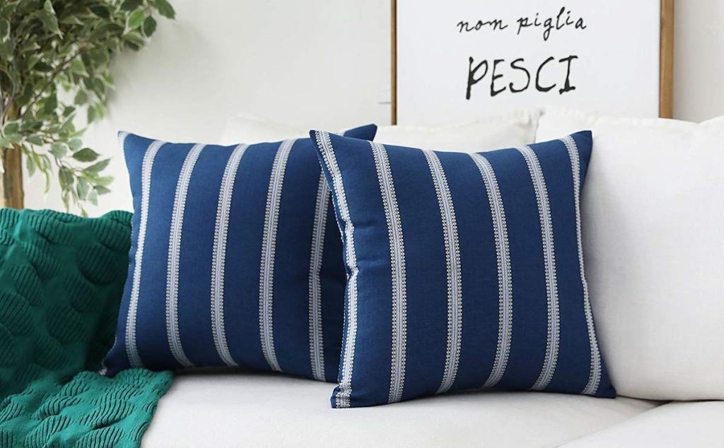 two stripe pillows navy and cream color on couch