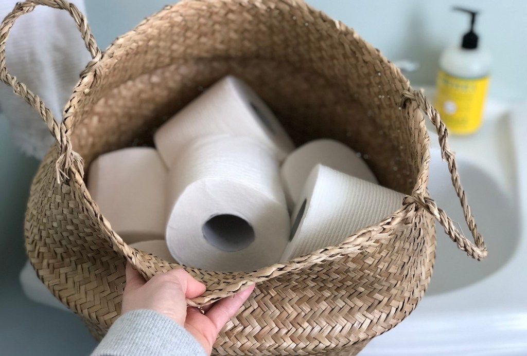 toilet paper rolls inside of a seagrass belly basket 