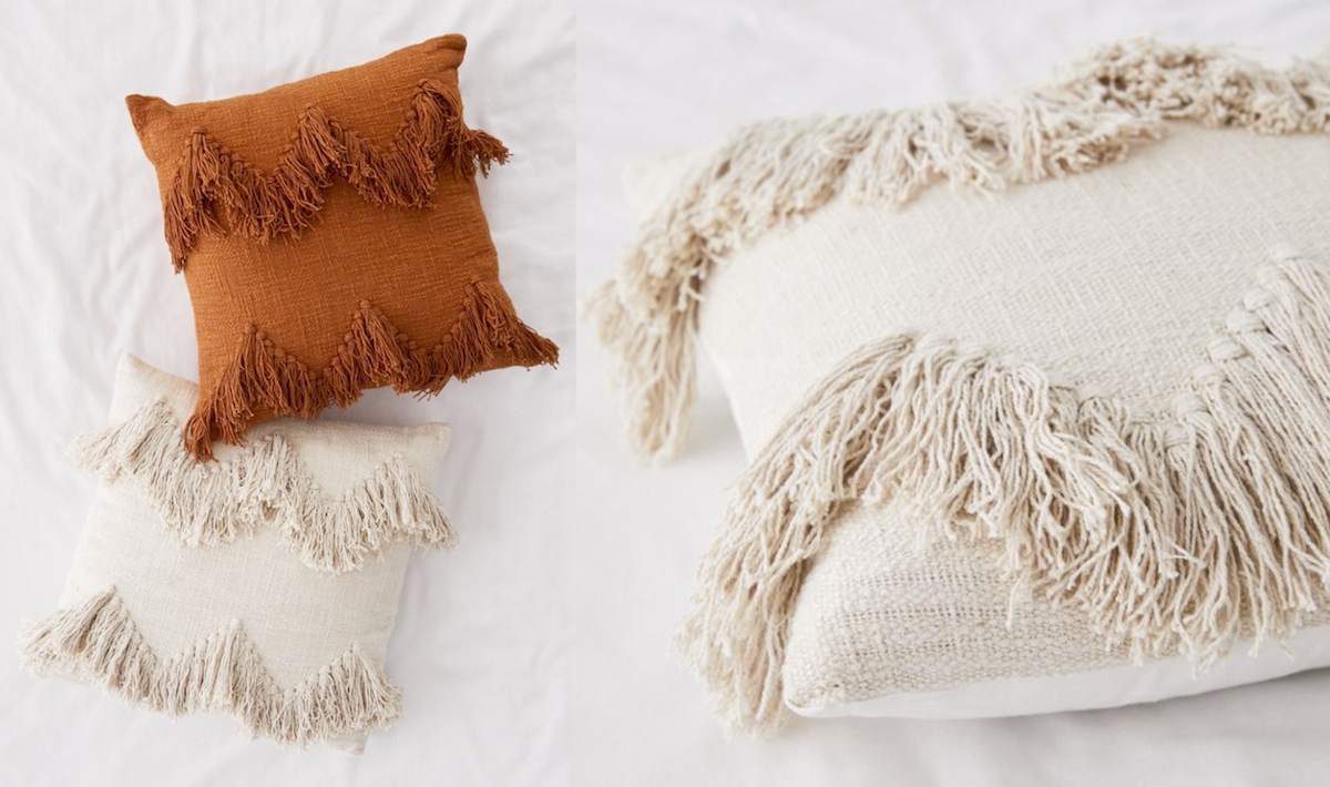 fringe tassel pillows on bed in terracotta cream, off white, ivory 