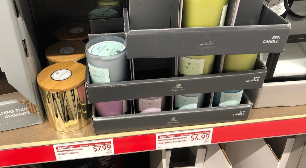 various candle on a store shelf gold blue green and purple