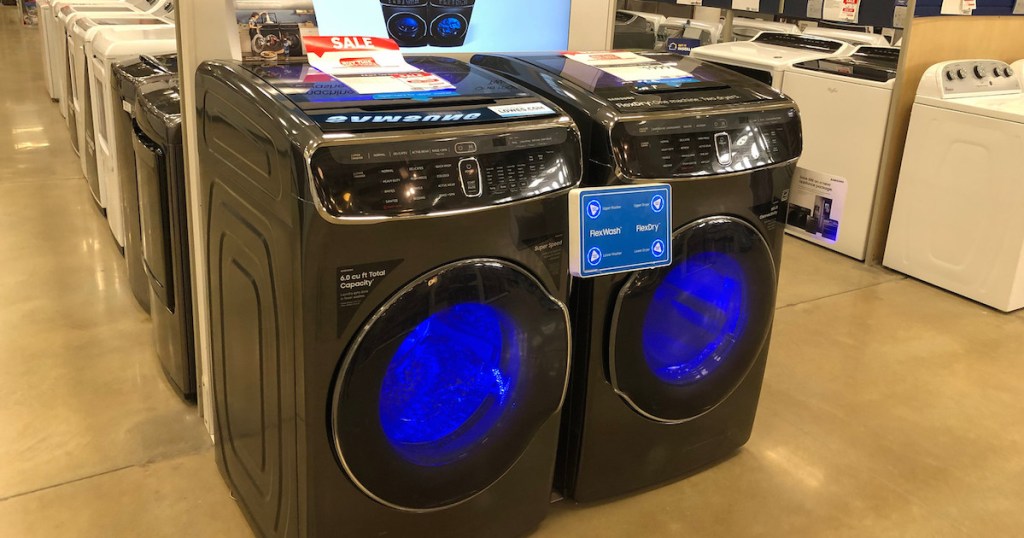 gray colored front loading washing machine and dryer with blue lights