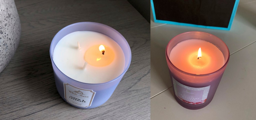 two purple candles with one wick on each burning