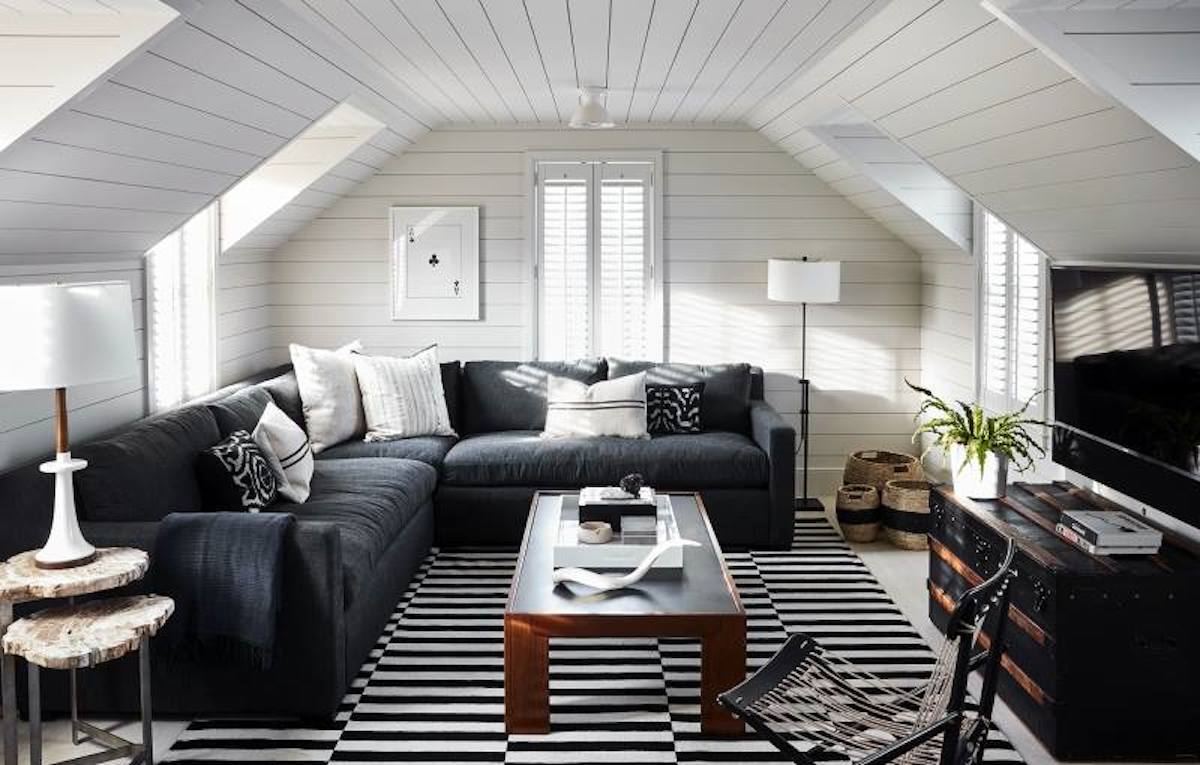 white shiplap walls with charcoal colored sectional couch and TV