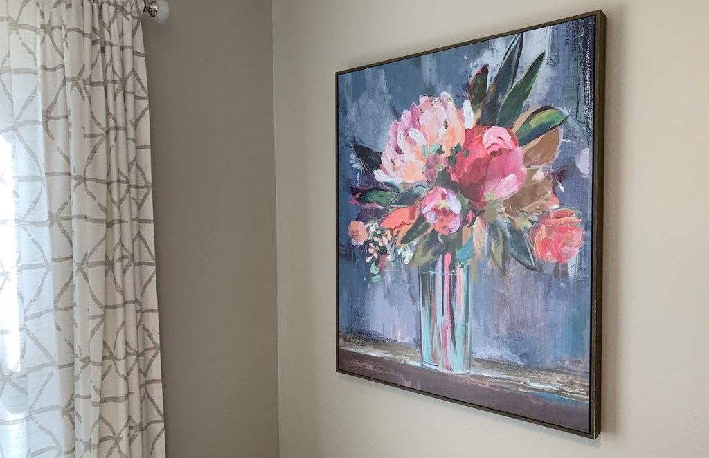 large floral artwork hanging on gray wall with curtains