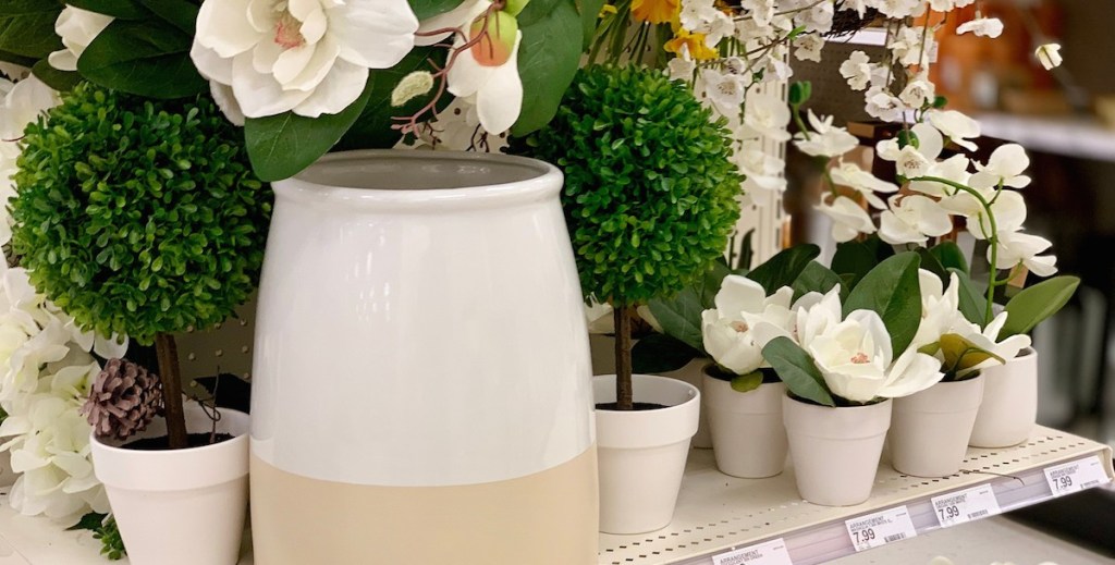 faux white florals with assorted pots and planters on shelf