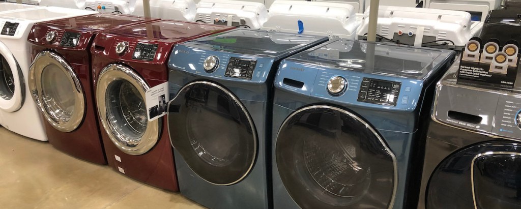 white red blue washers and dryers machines in store on the floor