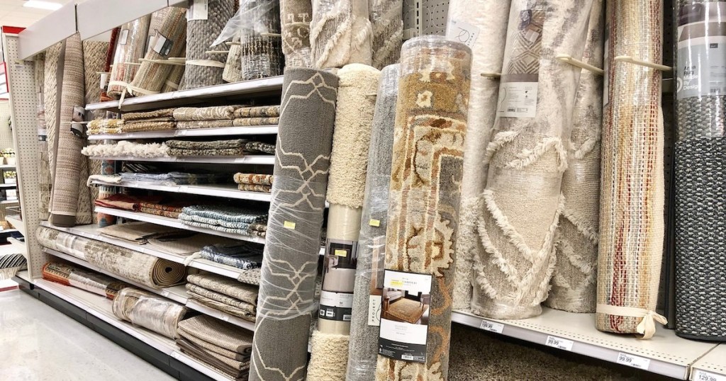 rolled rugs in store aisle leaning against shelves