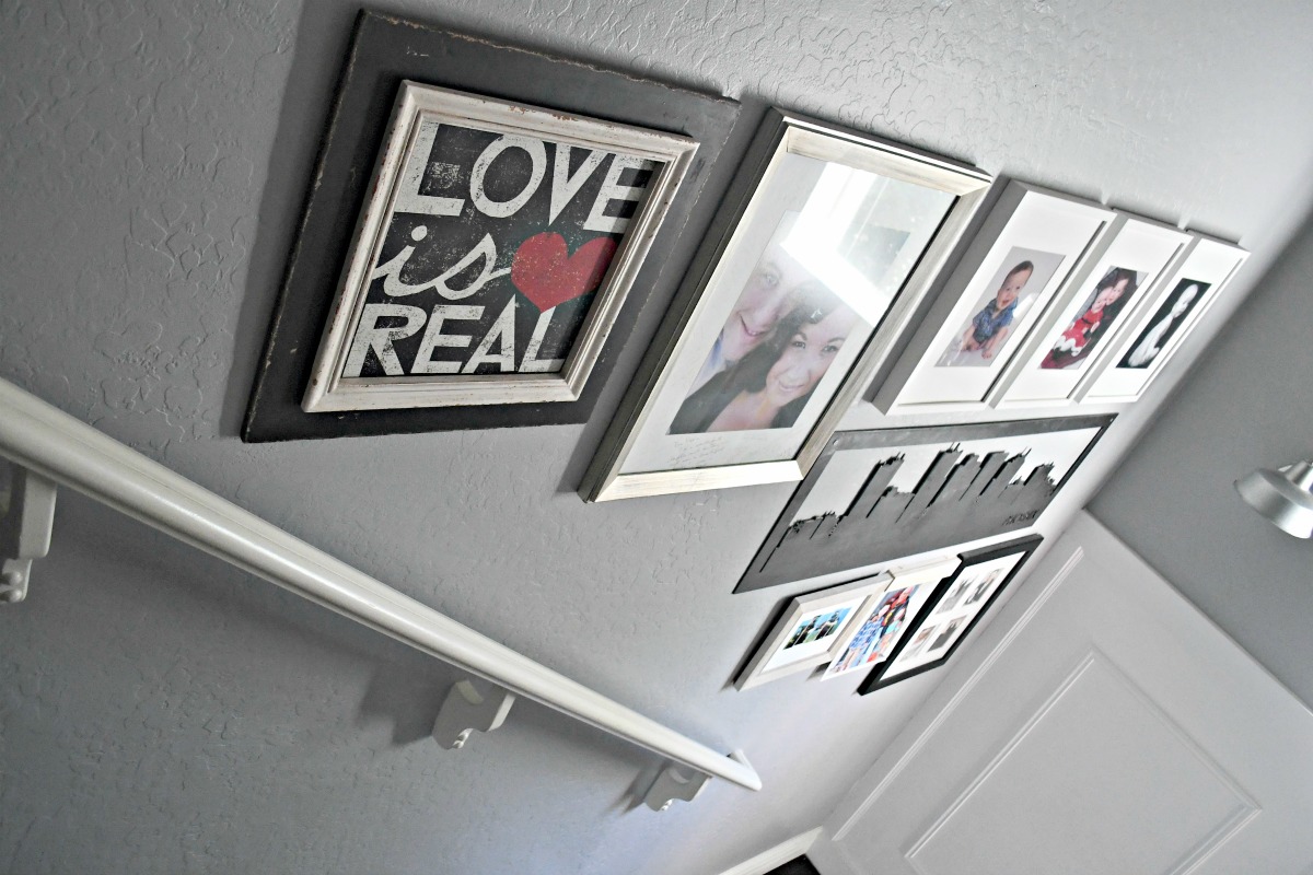 frames displayed up the stairs in a gallery wall 