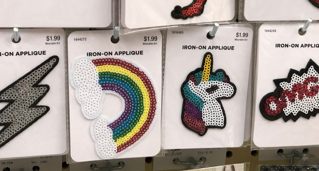rainbow and unicorn iron on appliques on a peg shelf