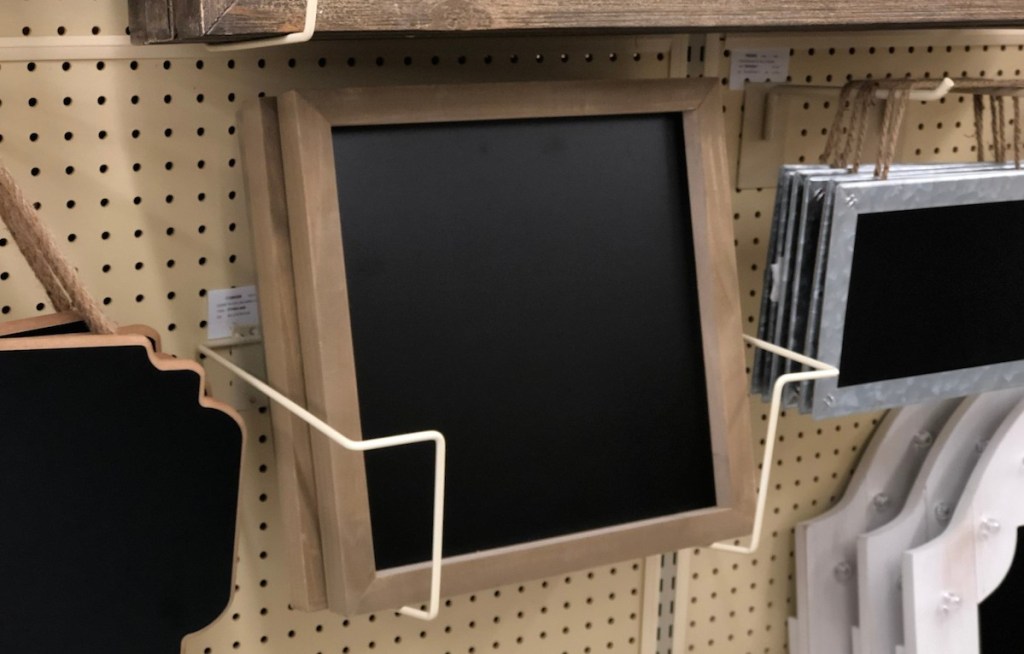 square wood framed chalkboards sitting on shelf