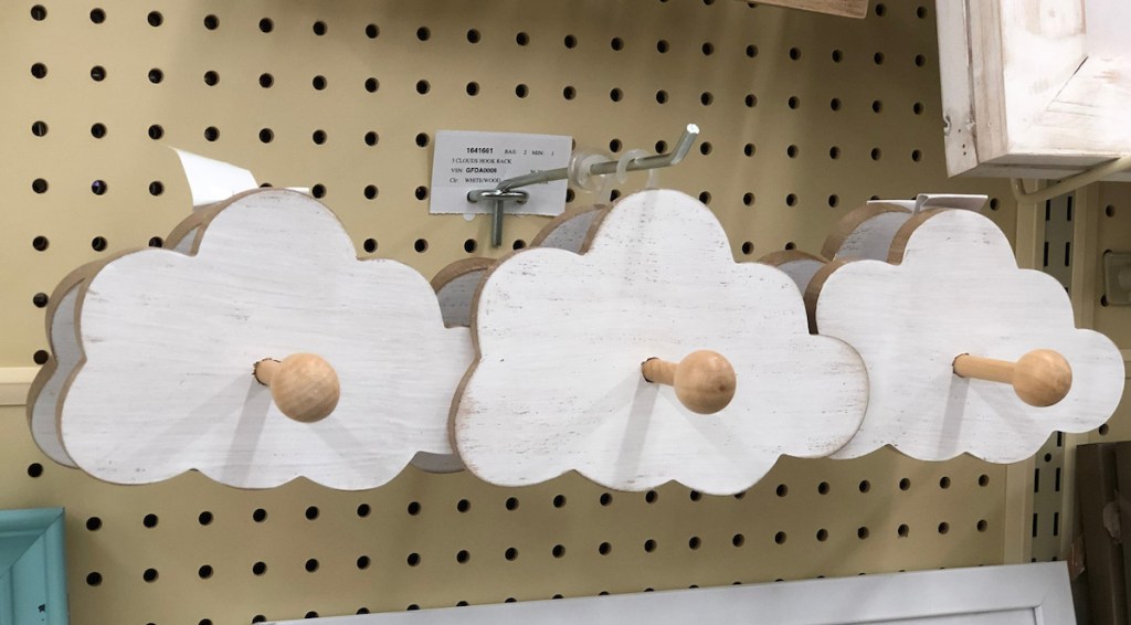 wood cloud shaped hooks hanging on shelf