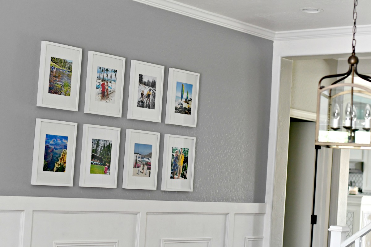 grid style gallery wall with white frames on a gray wall 