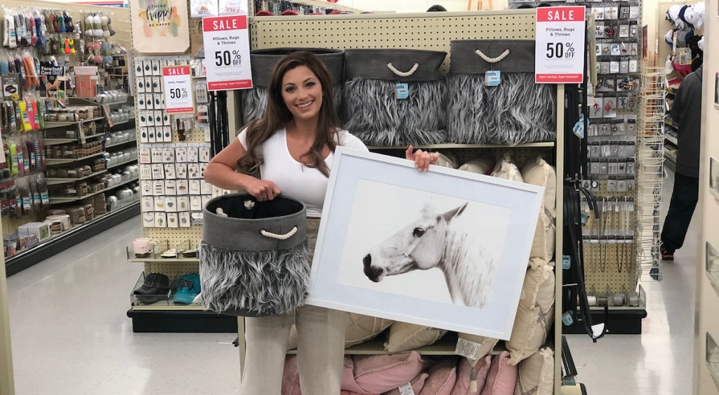 sara holding a white horse picture with faux fur gray basket in store