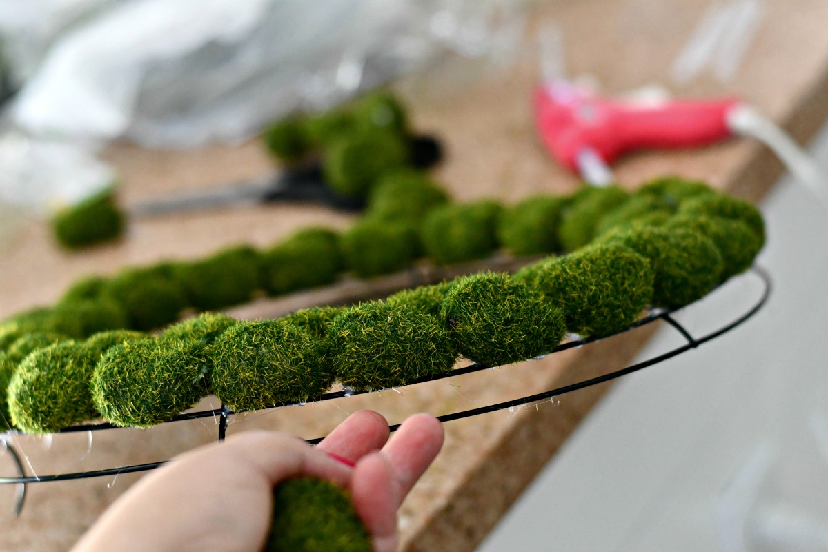 closeup of the moss wreath from the side as it's attached to the wire frame