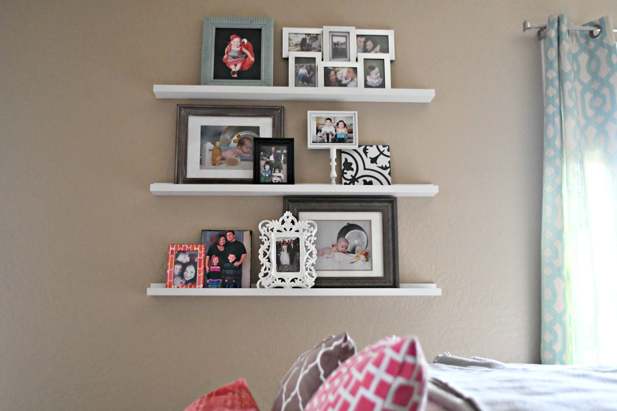 photos displayed on Ikea picture ledges as a gallery wall 