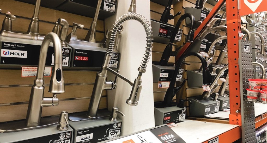 stainless steel kitchen faucets on store shelves in a row