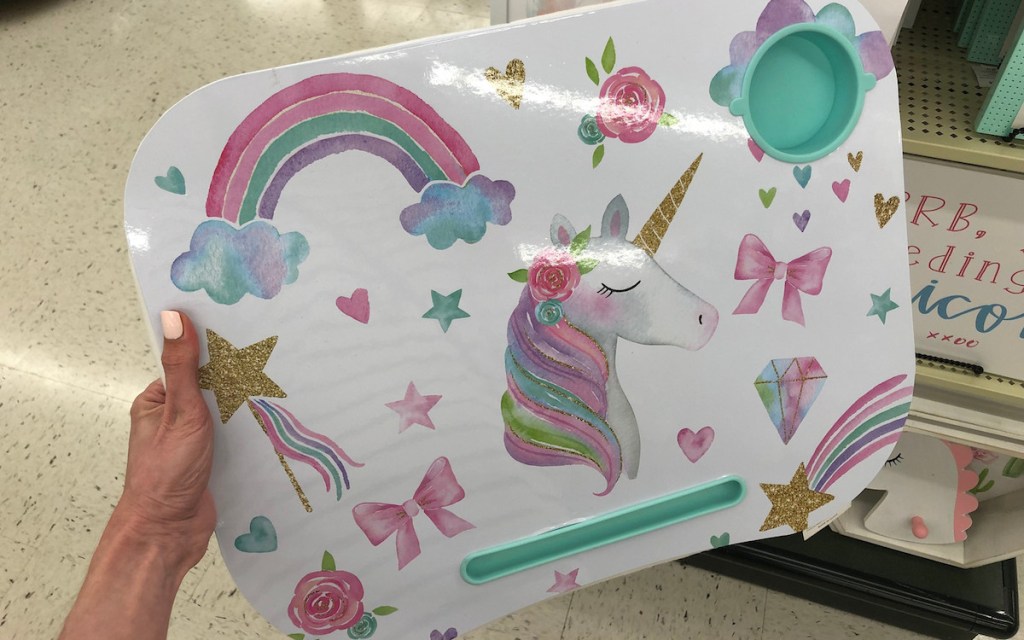 hand holding a unicorn and rainbow tray with cup holder