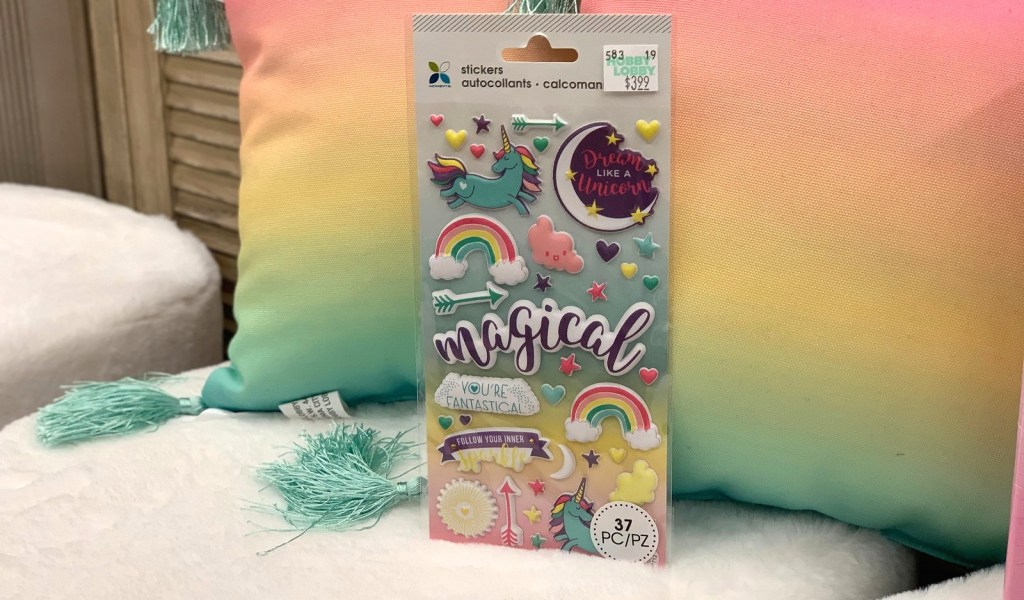 unicorn and rainbow sticker pack leaning on rainbow pillows