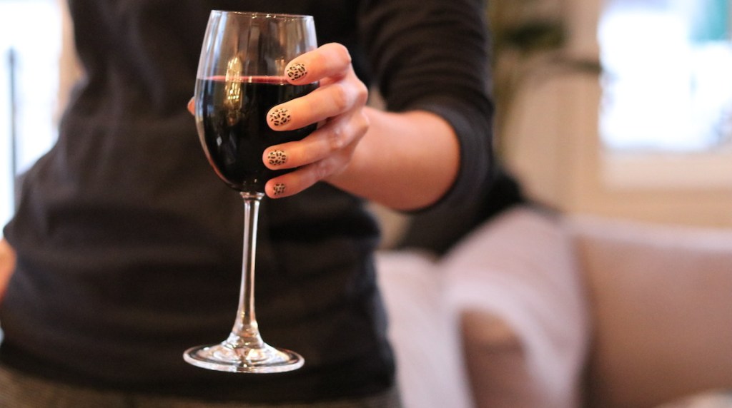 hand holding a glass of red wine
