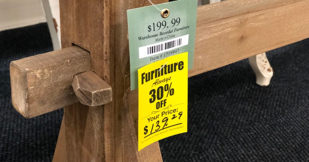 close up photo of wood with yellow furniture sale sign