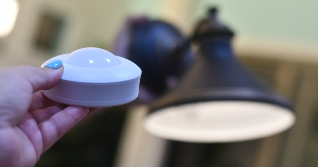 placing a wireless battery-operated light puck inside of a wall sconce