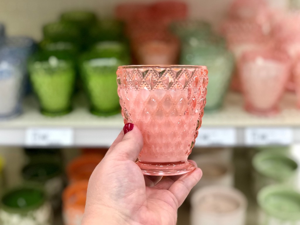 holding Opalhouse pink glass candle 