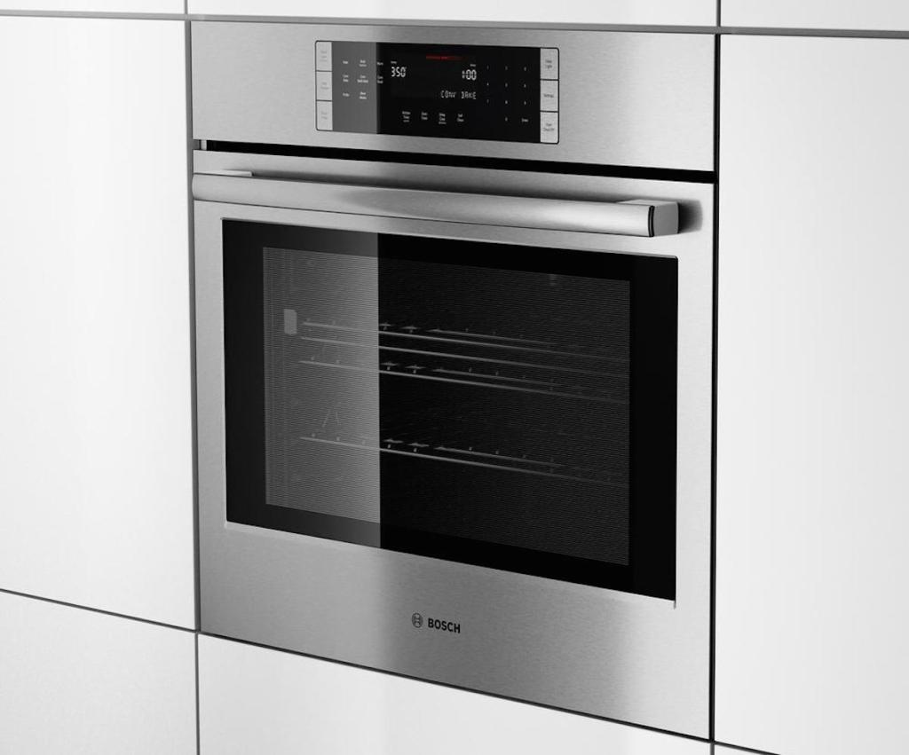 built in modern stainless steel wall oven with sleek white cabinets surrounding it