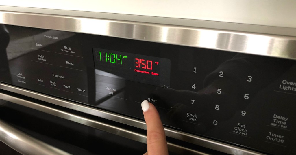 finger pointing at red 350 degrees convection bake button on wall oven