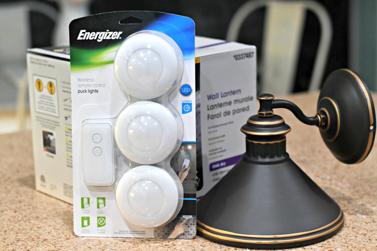 three-light puck pack next to a wall sconce