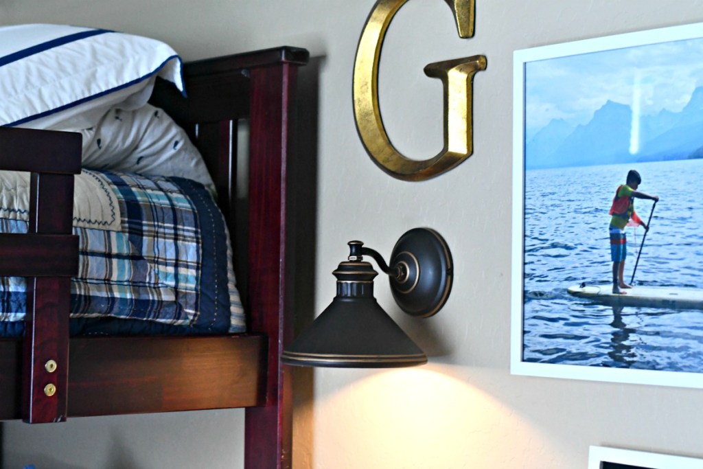 example of faux lighting with a sconce and puck light above a bed 