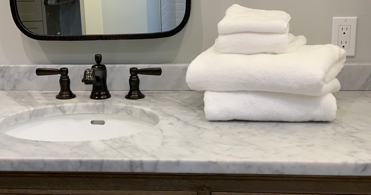 a stack of luxury towels on a marble counter
