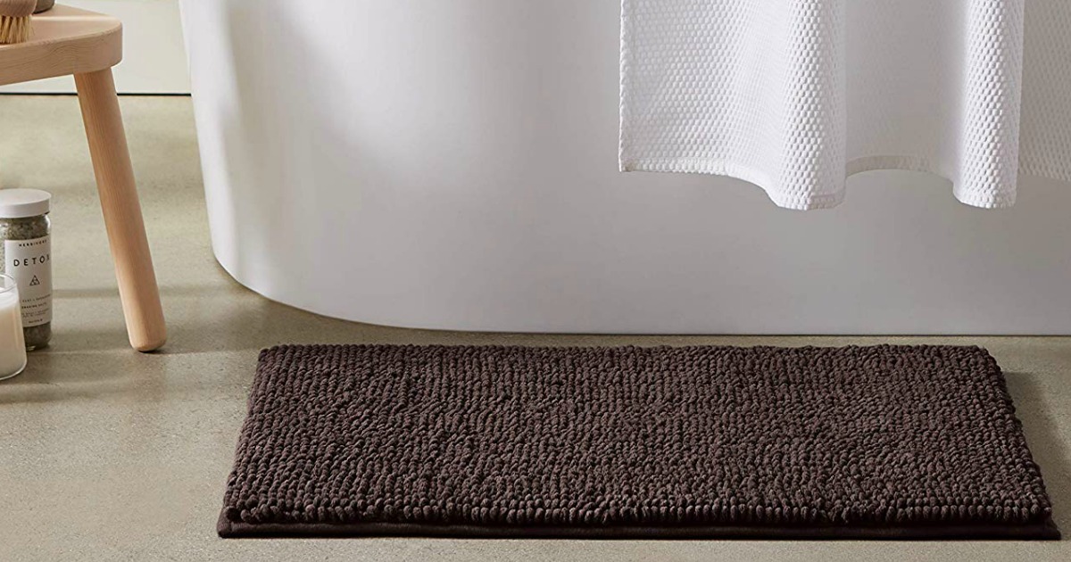 brown bath mat on bathroom floor 