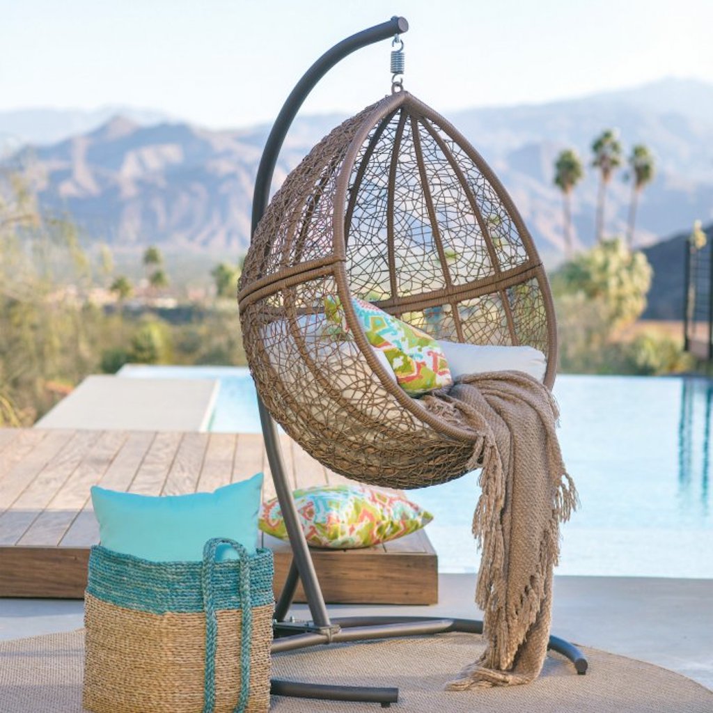 wicker hanging egg chair + stand by pool