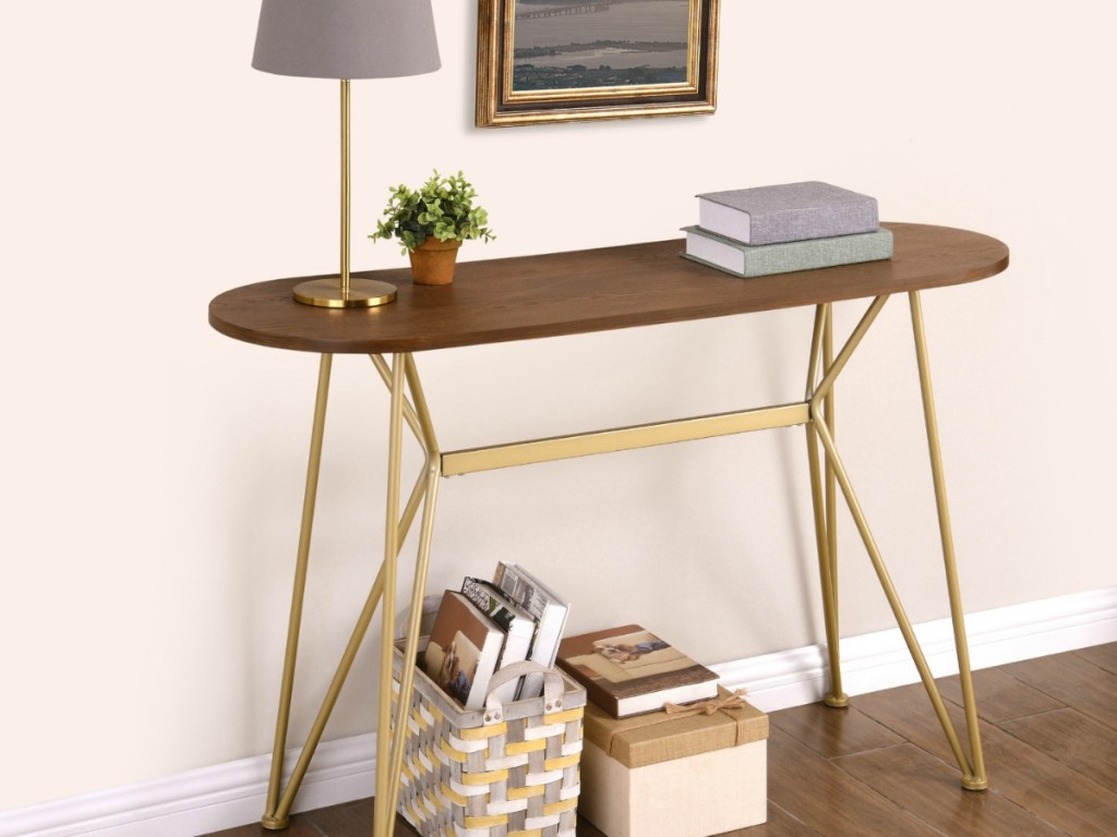 wood top table with gold legs near entryway