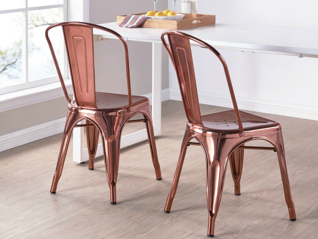 two chairs made from metal by table