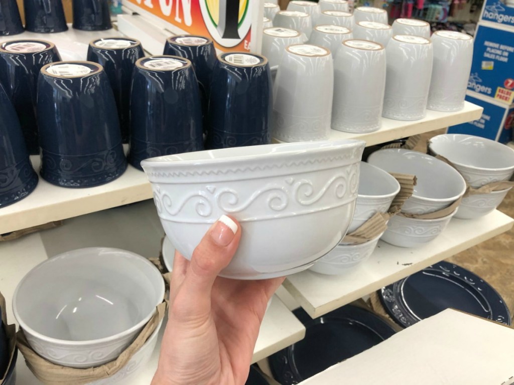 Hand holding white embossed bowl